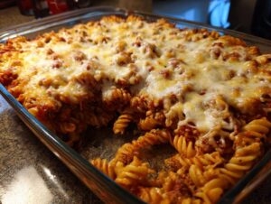 A close-up of an easy lasagna casserole made with rotini pasta and topped with melted cheese.