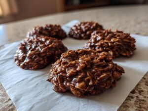A close-up of several no bake oatmeal cookies, showcasing their rich chocolate and oat texture.