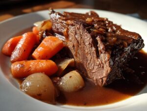 A close-up of a succulent slow cooker pot roast served with tender carrots and onions in a rich gravy.