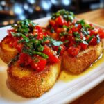 Close-up of delicious Bruschetta topped with fresh tomatoes, basil, and drizzled with olive oil.
