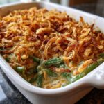Close-up of a freshly baked Grandma's Amazing Green Bean Casserole topped with crispy fried onions.