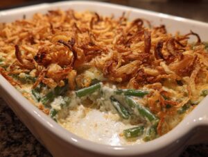 Close-up of a creamy Grandma's Amazing Green Bean Casserole topped with crispy fried onions.