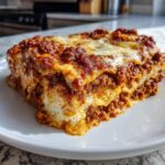 A delicious slice of hearty lasagna with layers of pasta, rich meat sauce, and melted cheese.