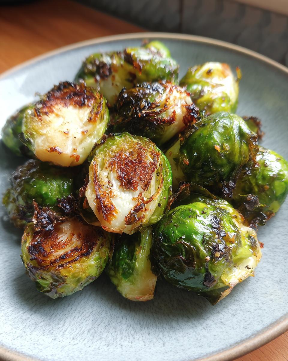 Close-up of perfectly roasted Brussels sprouts, showcasing their crispy edges and vibrant green color.