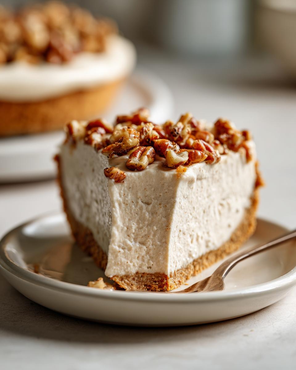 Close-up of a thick slice of pecan cream pie with a creamy filling and toasted pecans on top.