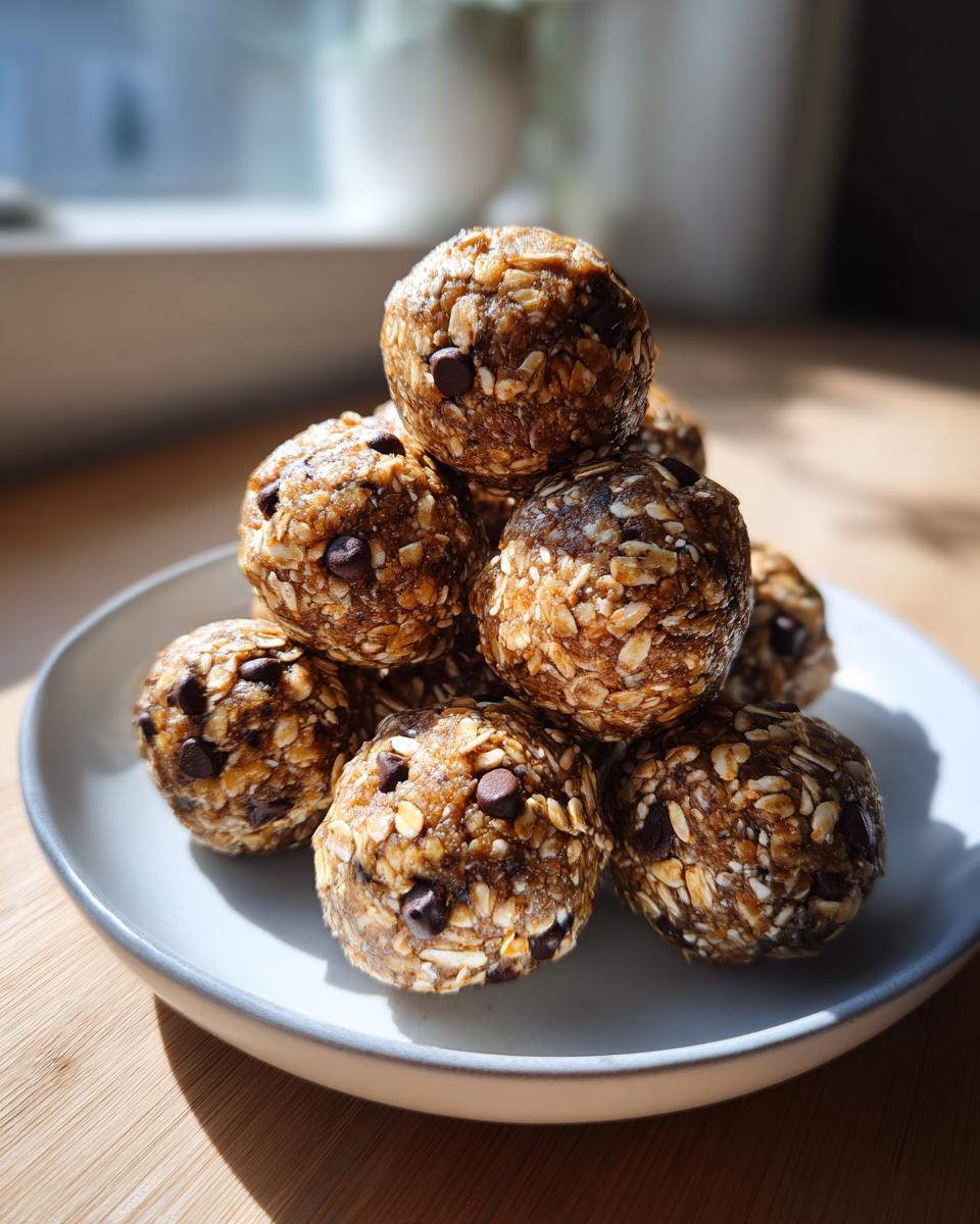 A stack of homemade chocolate chip protein balls made with oats, sitting on a light blue plate.