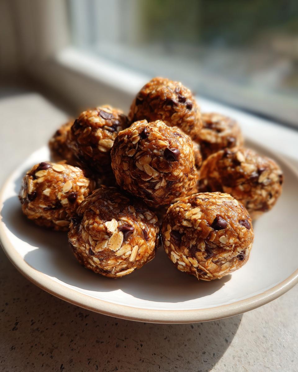 A stack of delicious, homemade protein balls made with oats and chocolate chips, sitting on a light plate.