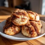 A stack of soft, round coffee cake cookies generously coated in cinnamon sugar topping.