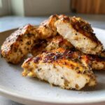 Close-up of perfectly cooked chicken pieces, showing the moist interior after using the chicken marinade.