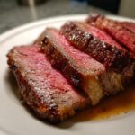 Close-up of perfectly medium-rare prime rib slices showing a deep brown crust and pink interior.