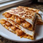 Close-up of perfectly grilled shrimp quesadilla wedges stuffed with seasoned shrimp and melted cheese.