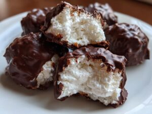 Close-up of chocolate-covered Cool Whip candy pieces, showing the fluffy white interior.