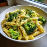 A close-up of creamy penne pasta mixed with bright green broccoli florets, a perfect example of quick broccoli pasta.