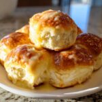 Close-up of warm, fluffy texas roadhouse rolls covered in a sweet, melted butter glaze.