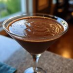 Close-up of a thick, rich chocolate martini served in a classic martini glass.